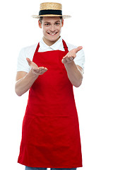 Image showing Handsome young male chef welcoming with smile