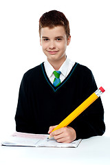 Image showing School boy writing on notebook