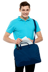 Image showing Guy taking out paper from his laptop bag