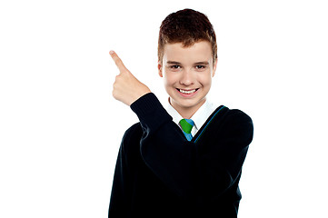 Image showing Happy young boy indicating upwards