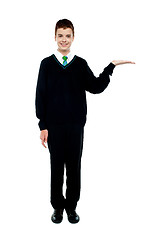 Image showing Full length shot of boy presenting copy space