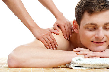 Image showing Attractive young man getting spa massage