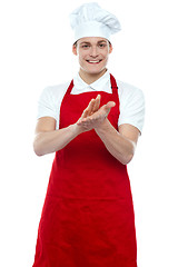 Image showing Isolated young handsome male chef clapping