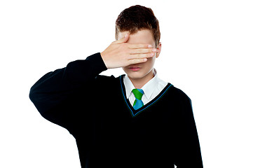 Image showing Boy hiding his face and eyes with hand