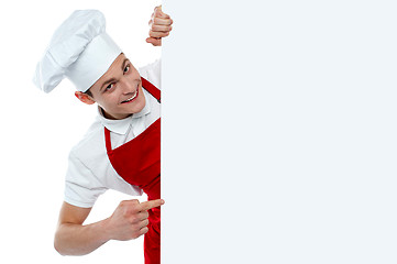 Image showing Male chef indicating at blank menu