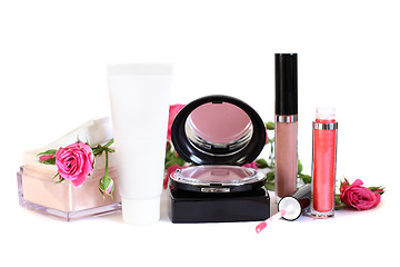 Image showing Cosmetics - makeup powder, cream, blush, lip gloss and flowers o