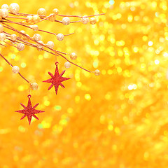 Image showing Christmas background with red star and gold glittering bokeh 
