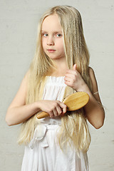 Image showing Girl combing hair