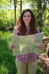 Image showing Hiker is reading a map