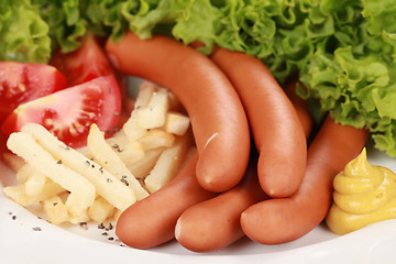 Image showing Sausages and french fries