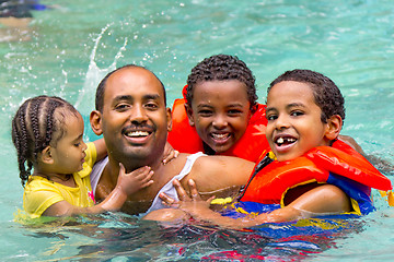 Image showing Family fun at the pool