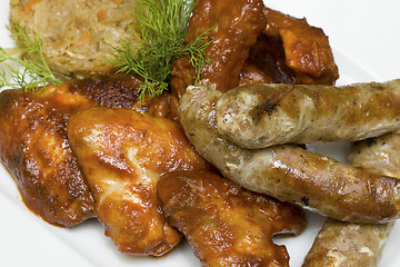 Image showing Snack - chicken wings, sausages, pork ribs and cabbage - German 