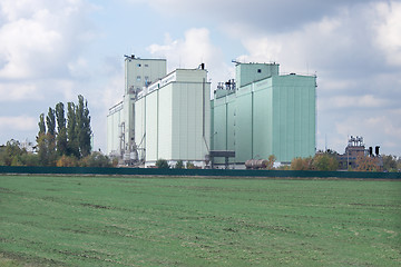 Image showing Grain elevator rises among the fields