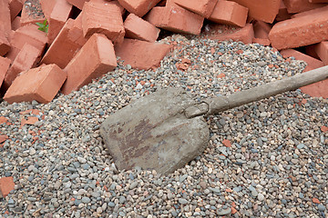 Image showing Red clay bricks lying on the gravel