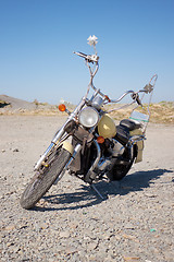 Image showing Old motorcycle is in a vacant lot autumn day