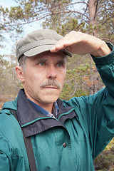 Image showing An elderly traveller looking into the distance