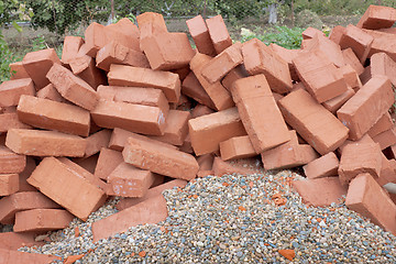 Image showing Red clay bricks lying on the gravel