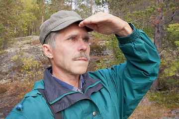 Image showing An elderly traveller looking into the distance