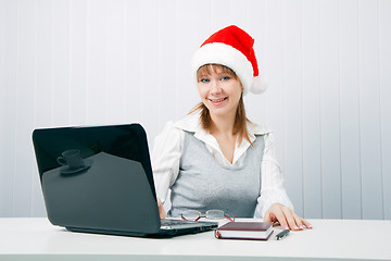 Image showing attractive business woman in Christmas hat