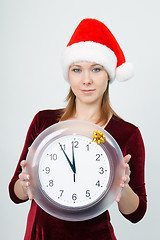 Image showing young attractive girl with a clock