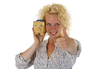 Image showing Beautiful young woman with piggy bank