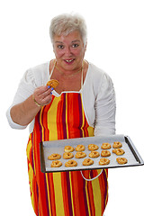 Image showing Female senior with cookies 