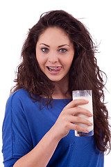 Image showing beautiful smiling woman is drinking milk