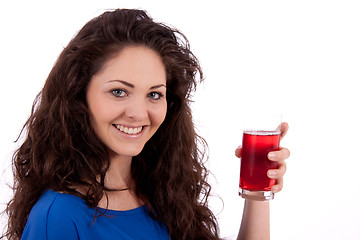 Image showing beautiful smiling brunette woman is drinking red juice