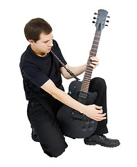 Image showing young singer, dressed in black with an electric guitar