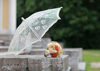 Image showing parasol and a bouquet