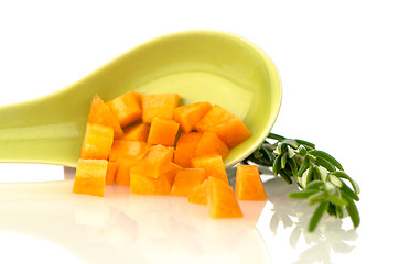Image showing Green ceramic spoon with carrot pieces
