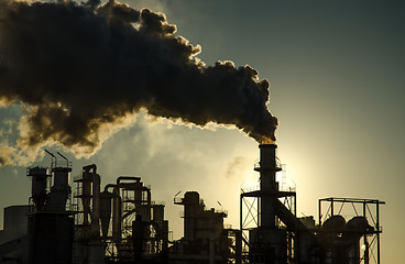 Image showing Smoking chimney  at sunset 