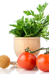 Image showing Tomatoes and green herb leafs 