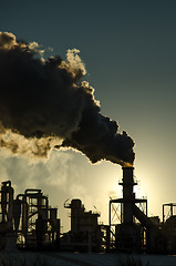 Image showing Smoking chimney  at sunset 