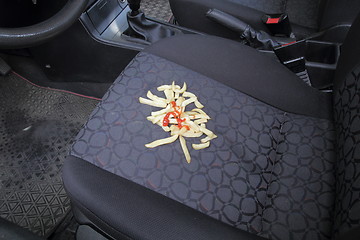 Image showing French fries on a car seat