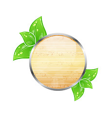 Image showing Wooden circle board with eco green leaves