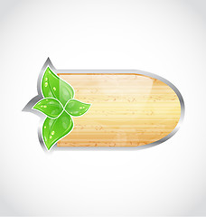 Image showing Wooden board with eco green leaves