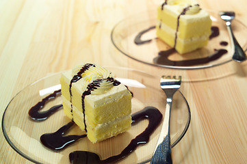 Image showing fresh cream cake closeup with chocolate sauce