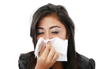 Image showing Pretty caucasian businesswoman blowing her nose in the office. 