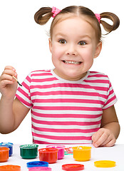 Image showing Cute cheerful child play with paints