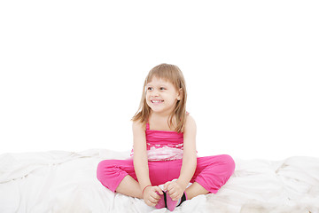 Image showing Portrait of a cute little girl sitting on floor, isolated over w