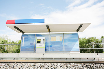 Image showing Two blue billboards at a train stop