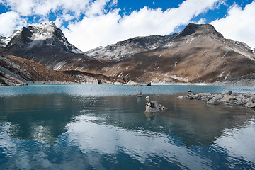 Image showing Balance and harmony: Stone stacks and Sacred Lake near Gokyo