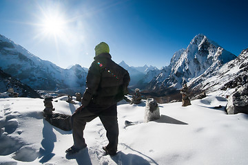 Image showing Climber and Cho La pass at daybreak in Himalayas