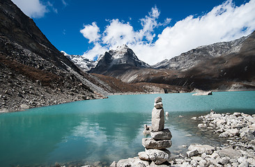 Image showing Harmony and balance: Pebble stack and Sacred Lake in Himalayas