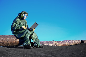 Image showing Scientist with a laptop on chemically contaminated area