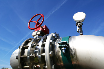 Image showing industrial pipelines and valve with a natural blue background