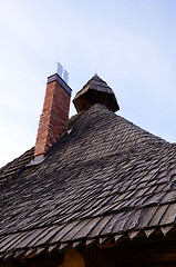 Image showing retro vintage wooden roof new red brick chimney 