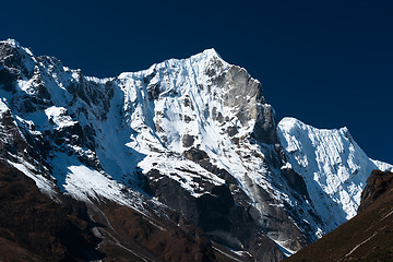 Image showing Snowbound mountain range and blue sky in Himalayas