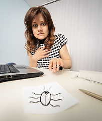 Image showing Woman scared with paper cockroach